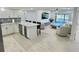 Open concept living space with modern kitchen, breakfast bar, and living area at 1001 S Bayshore Blvd # 205, Safety Harbor, FL 34695