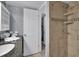 Bathroom with shower stall and granite vanity at 12924 Gulf Blvd # 307, Madeira Beach, FL 33708