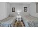 Guest bedroom with two twin beds, nightstand, and coastal decor at 12924 Gulf Blvd # 307, Madeira Beach, FL 33708