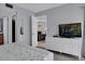 Primary bedroom with dresser, TV, and access to bathroom at 12924 Gulf Blvd # 307, Madeira Beach, FL 33708