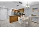 Kitchen with island, stainless steel appliances, and dining area at 12924 Gulf Blvd # 307, Madeira Beach, FL 33708