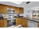 Stainless steel appliances and wood cabinets in this kitchen at 12924 Gulf Blvd # 307, Madeira Beach, FL 33708