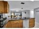 Kitchen with breakfast bar, stainless steel appliances, and view of living room at 12924 Gulf Blvd # 307, Madeira Beach, FL 33708