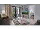 Living room with comfortable seating, TV, and access to balcony at 12924 Gulf Blvd # 307, Madeira Beach, FL 33708