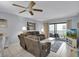 Living room with sectional sofa and access to balcony at 12924 Gulf Blvd # 307, Madeira Beach, FL 33708