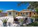 Renovated beach cottage with patio furniture and tropical plants at 14081 W Parsley Dr, Madeira Beach, FL 33708