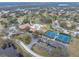 Aerial view of community with pool, tennis courts, and clubhouse at 1559 Glengarry Dr, Palm Harbor, FL 34684