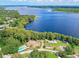 Aerial view of community, highlighting lakefront location and clubhouse at 1559 Glengarry Dr, Palm Harbor, FL 34684
