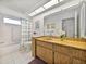 Double sink bathroom with a shower and tub at 1559 Glengarry Dr, Palm Harbor, FL 34684