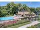 Inviting community pool with a clubhouse and lush landscaping at 1559 Glengarry Dr, Palm Harbor, FL 34684