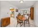 Bright dining room with wood table and chairs, kitchen view at 1559 Glengarry Dr, Palm Harbor, FL 34684