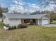 Ranch-style home with stone accents and a well-maintained lawn at 1559 Glengarry Dr, Palm Harbor, FL 34684