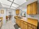 Kitchen with light wood cabinets, double sink, and dishwasher at 1559 Glengarry Dr, Palm Harbor, FL 34684