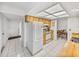 Kitchen features white appliances and wood cabinets at 1559 Glengarry Dr, Palm Harbor, FL 34684