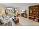 Living room with sofa, bookcase, and coffee table at 1559 Glengarry Dr, Palm Harbor, FL 34684