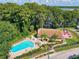 Aerial view of community pool and clubhouse near lake at 1559 Glengarry Dr, Palm Harbor, FL 34684