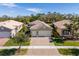 House with a two-car garage, paver driveway and nicely landscaped at 16122 Cedar Key Dr, Wimauma, FL 33598