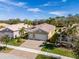 House with a two-car garage and nicely landscaped front yard at 16122 Cedar Key Dr, Wimauma, FL 33598