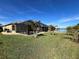 Large backyard with a screened-in pool and lush green lawn at 16122 Cedar Key Dr, Wimauma, FL 33598