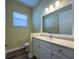 Bathroom with a vanity, toilet, and large mirror at 16122 Cedar Key Dr, Wimauma, FL 33598