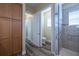 A well-lit bathroom with a toilet, shower and walk-in closet at 16122 Cedar Key Dr, Wimauma, FL 33598