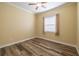 Bright bedroom with wood-look floors and neutral walls at 16122 Cedar Key Dr, Wimauma, FL 33598