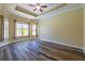 Bright bedroom featuring bay windows and hardwood floors at 16122 Cedar Key Dr, Wimauma, FL 33598