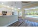 Open kitchen with pool view and breakfast bar at 16122 Cedar Key Dr, Wimauma, FL 33598