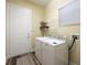 Bright laundry room with washer, dryer, and shelving at 16122 Cedar Key Dr, Wimauma, FL 33598