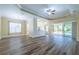 Open living room with view of pool and sliders at 16122 Cedar Key Dr, Wimauma, FL 33598