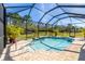 Enclosed pool area with screened enclosure and landscaping at 16122 Cedar Key Dr, Wimauma, FL 33598