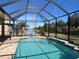 Enclosed pool area with screened enclosure and landscaping at 16122 Cedar Key Dr, Wimauma, FL 33598