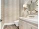 Stylish powder room with a modern vanity and unique wallpaper at 16220 Villarreal De Avila, Tampa, FL 33613