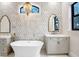 Bathroom with a freestanding bathtub, dual vanities, and marble tile at 16220 Villarreal De Avila, Tampa, FL 33613