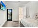 Bright bedroom with wood floors, ensuite bathroom access, and private balcony at 16220 Villarreal De Avila, Tampa, FL 33613
