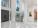 Elegant two-story foyer with marble floors, a grand staircase, and a stunning chandelier at 16220 Villarreal De Avila, Tampa, FL 33613