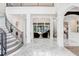 Bright and spacious foyer with marble floors and a curved staircase at 16220 Villarreal De Avila, Tampa, FL 33613