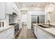 Luxury kitchen featuring a large island, stainless steel appliances, and marble countertops at 16220 Villarreal De Avila, Tampa, FL 33613