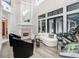 Elegant living room with a white sofa, black armchairs, and a fireplace at 16220 Villarreal De Avila, Tampa, FL 33613