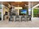 Modern outdoor kitchen with bar seating and grill at 16220 Villarreal De Avila, Tampa, FL 33613