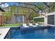 Relaxing pool area with lounge chairs and a covered patio at 16220 Villarreal De Avila, Tampa, FL 33613
