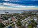 Aerial view of a coastal community showcasing waterfront properties and tree-lined streets at 1825 San Mateo Dr, Dunedin, FL 34698