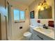 Clean bathroom with white tiled walls and updated vanity at 1825 San Mateo Dr, Dunedin, FL 34698