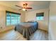 Spacious bedroom with large windows, hardwood floors, and a comfortable bed at 1825 San Mateo Dr, Dunedin, FL 34698
