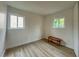 Simple bedroom with light walls and wood-look floors at 1825 San Mateo Dr, Dunedin, FL 34698