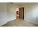 Bedroom with wood-look floors and access to another room at 1825 San Mateo Dr, Dunedin, FL 34698