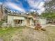 Charming light green house with a white picket fence at 1825 San Mateo Dr, Dunedin, FL 34698