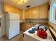 Full view of kitchen, granite counters, wood cabinets at 1825 San Mateo Dr, Dunedin, FL 34698