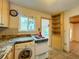 Kitchen area with a washer, granite counters and wood cabinets at 1825 San Mateo Dr, Dunedin, FL 34698