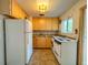 Galley kitchen with wood cabinets and granite countertops at 1825 San Mateo Dr, Dunedin, FL 34698